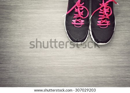Pair of sport shoes on grey wooden background, Sport wear, Sport fashion, Sport accessories, Sport equipment. (Vintage Style Color)