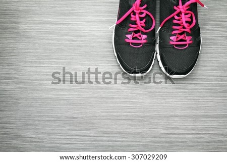 Pair of sport shoes on grey wooden background, Sport wear, Sport fashion, Sport accessories, Sport equipment.