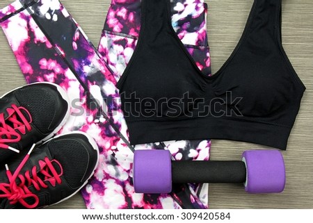 Women's sport wear and Dumbbell. Fitness wear and equipment. Sport fashion, Sport accessories, Sport equipment.