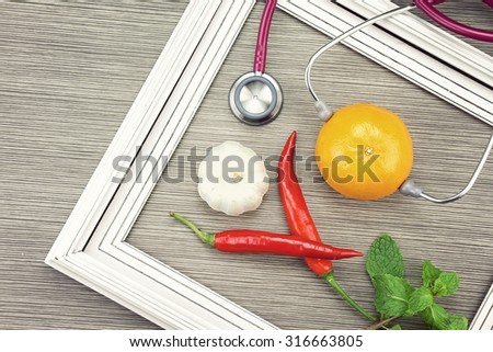 Stethoscope and herb on a wooden background. Medical equipment, Healthy food, Healthy eating concept. (Vintage Style Color)