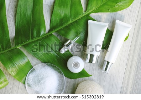 Cosmetic bottle containers with green herbal leaves, Blank label for branding mock-up, Natural beauty product concept. (Color Processed)