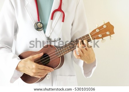 Doctor playing ukulele, Music therapy concept. (Selective Focus)