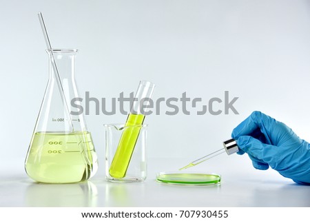 Scientist with drug research and lab glassware, Chemist dropping chemical substances, Medicine discovery at science lab.