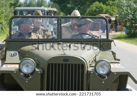CHERNOGOLOVKA, MOSCOW REGION, RUSSIA - JUNE 21, 2013: The crew of the Soviet military retro car GAZ-67 highway, 3rd international meeting \