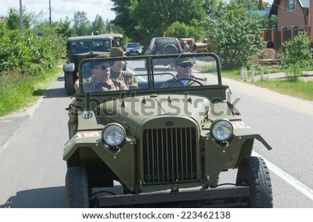 CHERNOGOLOVKA, MOSCOW REGION, RUSSIA - JUNE 21, 2013: Army retro car with crew GAZ-67 highway, 3rd international meeting \