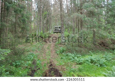 CHERNOGOLOVKA, MOSCOW REGION, RUSSIA-JUNE 21, 2013: American old car Dodge WC-51 rides in the forest on the hard road, 3rd international meeting \