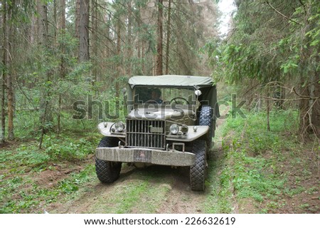 CHERNOGOLOVKA, MOSCOW REGION, RUSSIA-JUNE 21, 2013: American car Dodge WC-51 rides in the forest on the hard road, 3rd international meeting \