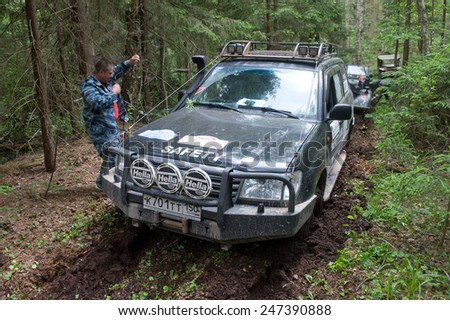 CHERNOGOLOVKA, MOSCOW REGION, RUSSIA-JUNE 21, 2013:Off-road vehicle Toyota Land Cruiser stuck on a forest road, 3rd international meeting \