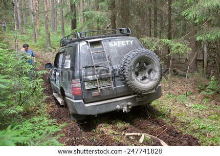 CHERNOGOLOVKA, MOSCOW REGION, RUSSIA - JUNE 21,2013:Off-road vehicle Toyota with the rope in the woods,3rd international meeting \