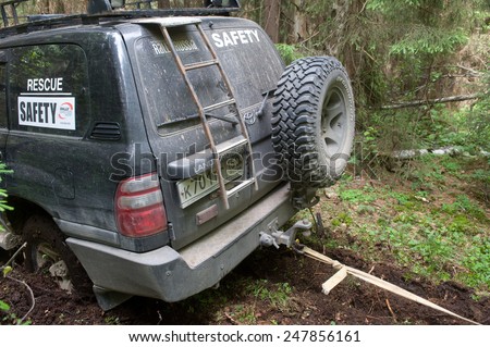 CHERNOGOLOVKA, MOSCOW REGION, RUSSIA - JUNE 21, 2013: Off-road vehicle Toyota Land Cruiser with the rope in the woods, 3rd international meeting 