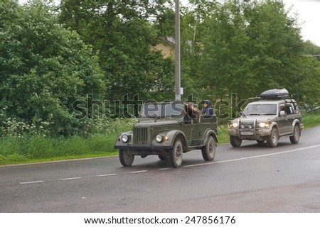 CHERNOGOLOVKA, MOSCOW REGION, RUSSIA - JUNE 21, 2013: Old Soviet car GAZ-69 goes on the road,  3rd international meeting \