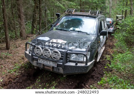 CHERNOGOLOVKA, MOSCOW REGION, RUSSIA - JUNE 21, 2013: Off-road vehicle Toyota Land Cruiser stuck in the woods, 3rd international meeting \