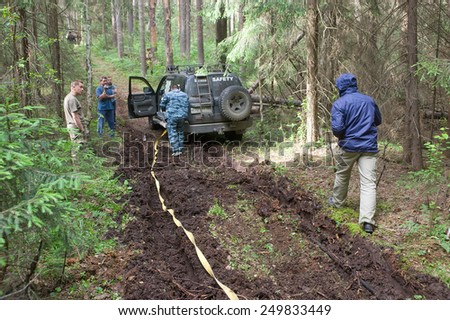 CHERNOGOLOVKA, MOSCOW REGION, RUSSIA - JUNE 21, 2013: Off-road vehicle Toyota Land Cruiser with expanded cable in the forest, 3rd international meeting \