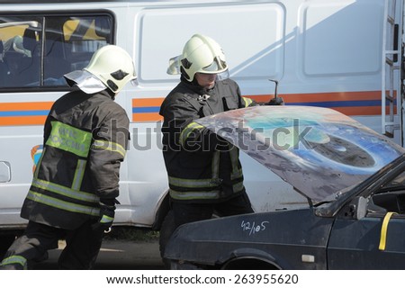 MOSCOW, RUSSIA - September 19, 2014: Firefighters open the hood and disconnect the battery emergency vehicle on the teachings of the Ministry of emergency situations, Moscow