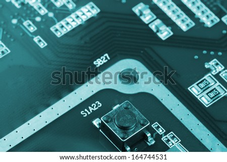 switch, chip capcitors, and chip resistors mounted on a Printed Wiring Board