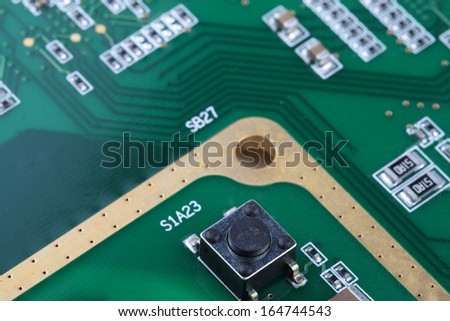 switch, chip capcitors, and chip resistors mounted on a Printed Wiring Board
