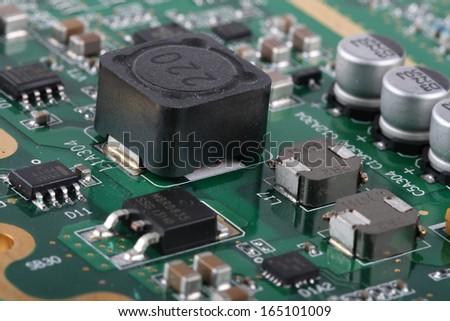 Application Specific Integrated Circuit, inductors, chip capacitors,electrolytic capacitors, and chip resistors mounted on a Printed Wiring Board