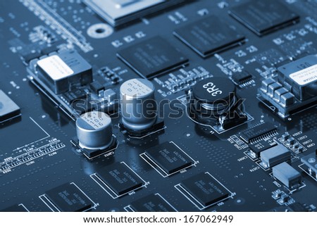 Application Specific Integrated Circuit, inductors, chip capacitors, electrolytic capacitors, Double Data Rate Synchronous Dynamic Random-access chips and resistors mounted on a Printed Wiring Board