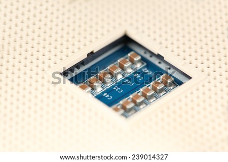 two rows of Chip Capacitors mounted in a socket array through Surface Mount Technology for large Scale Integrated Circuits mounted on a printed wiring board