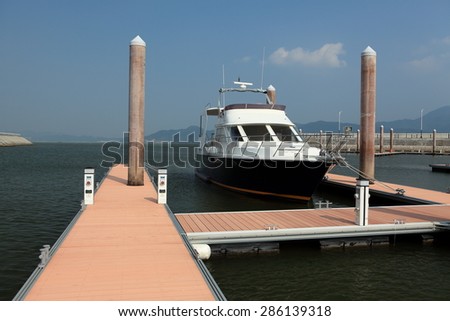a yacht docked at the marina with supply posts and mooring cleats and berth