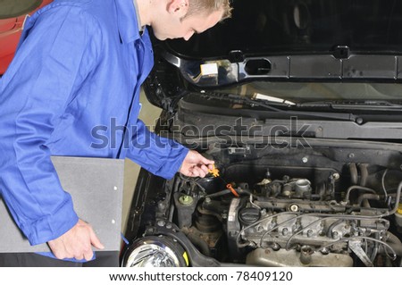 auto mechanic, mechatronic checked the engine compartment of a car in the garage