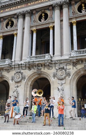 Paris,France - 28 May, 2014 : Les Plaies Mobiles, Young brass band show on Paris Opera building. Dozens buskers perform on the streets and in metro in Paris, France.