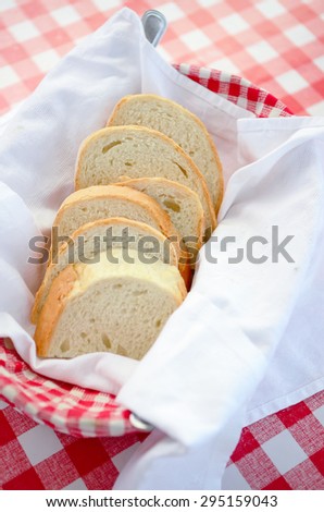 toast bread in plate basket, background is red plaid check dinner cloth, full of east europe style, such as Hungary, Bolgaria, Romania