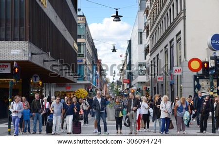 Stockholm, Sweden - August 18, 2014 - busy people shopping in downtown main street and wait for traffic light in Stockholm, Sweden.