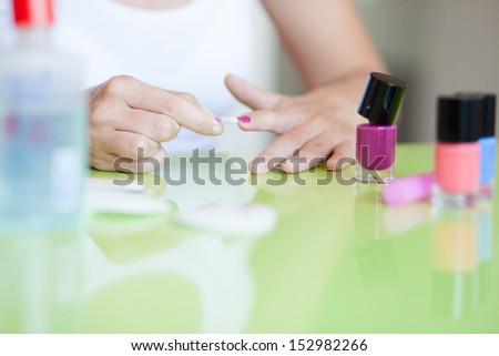 Home manicure. Woman taking care of her fingernails.