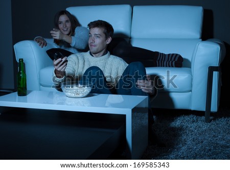 Couple watching a movie on TV