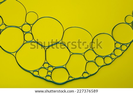 gold oil bubbles on a water surface abstract background