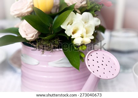 Romantic bouquet in flower pot in form of watering can
