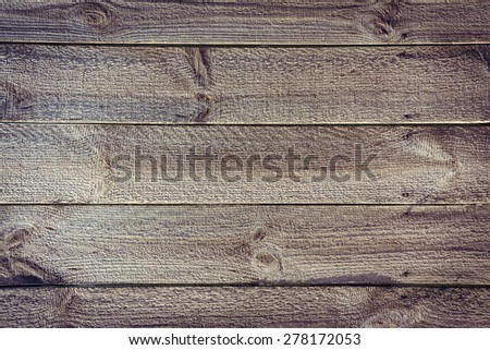 Rustic planked fence from horizontal wooden boards with nails