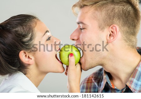 Healthy love. Couple sharing an apple.