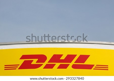 Vejle, Denmark - July 4, 2015: DHL logo on a facade. DHL Express is a division of the german logistics company Deutsche Post DHL providing international express mail services.