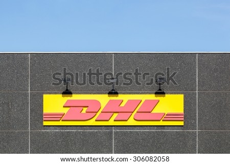 Skanderborg, Denmark - August 9, 2015: DHL logo on a facade. DHL Express is a division of the german logistics company Deutsche Post DHL providing international express mail services.