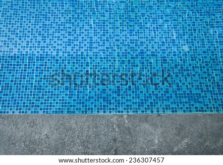 Swimming pool cement border with blue water texture