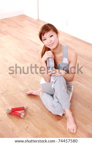 young Japanese woman resting after work out