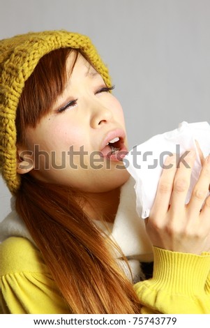 Young Japanese Woman Sneezing With Allergy Or Cold Stock Photo 75743779