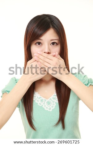 Japanese woman making the speak no evil gesture