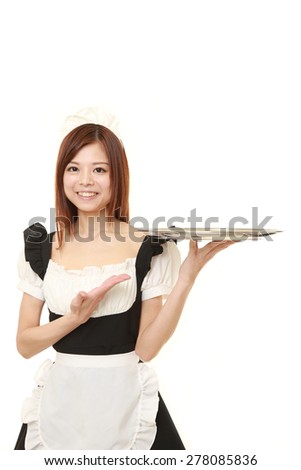 young Japanese woman wearing french maid costume with tray