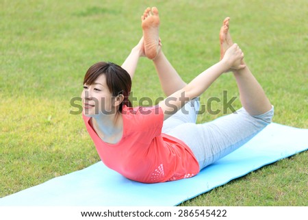 Japanese woman doing yoga bow pose