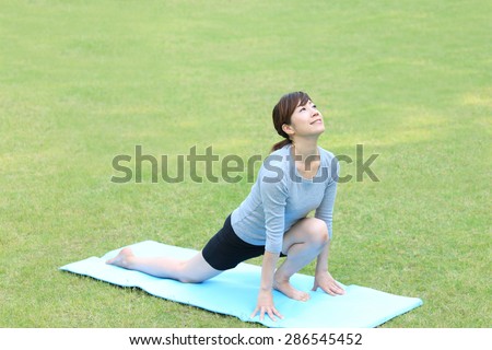 Japanese woman doing yoga High Lunge