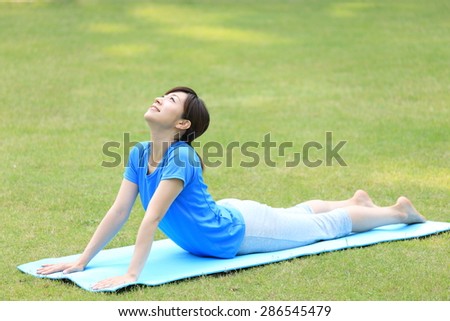 Japanese woman doing yoga Cobra Pose