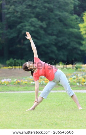 Japanese woman doing yoga triangle pose
