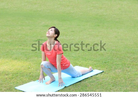 Japanese woman doing yoga High Lunge