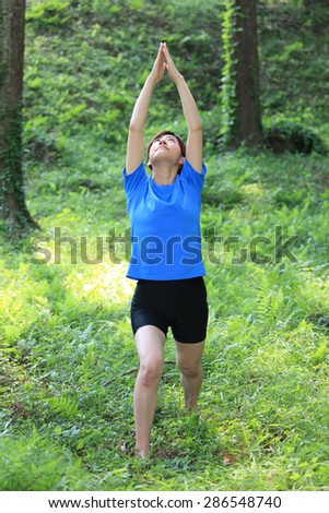 Japanese woman doing yoga warrior I pose