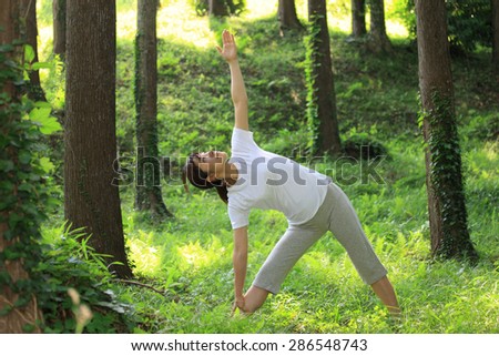 Japanese woman doing yoga triangle pose