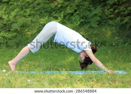 Japanese woman doing yoga Downward-Facing Dog
