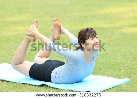 Japanese woman doing yoga bow pose